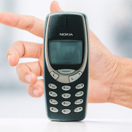 nokia 3310 with a hand reaching for it nostalgia