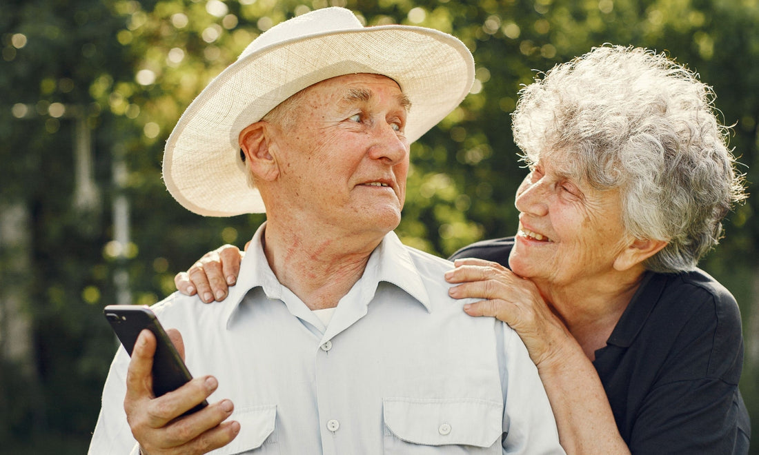 a grandma showing her elderly husband how a smartphone works