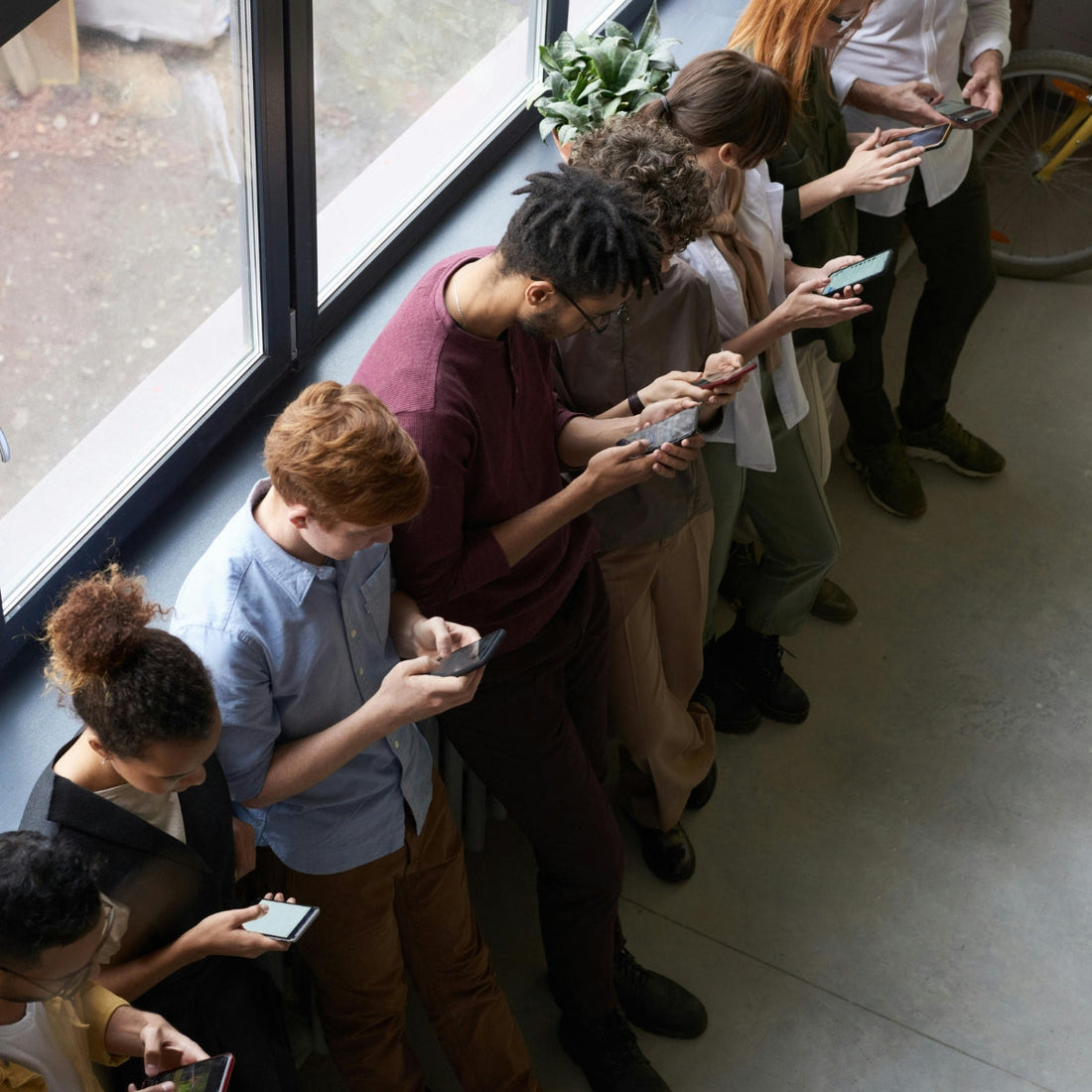 people busy with their phones in a corridor