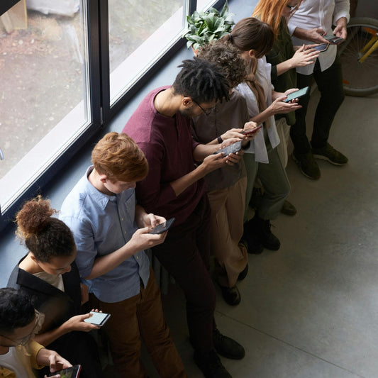 people busy with their phones in a corridor
