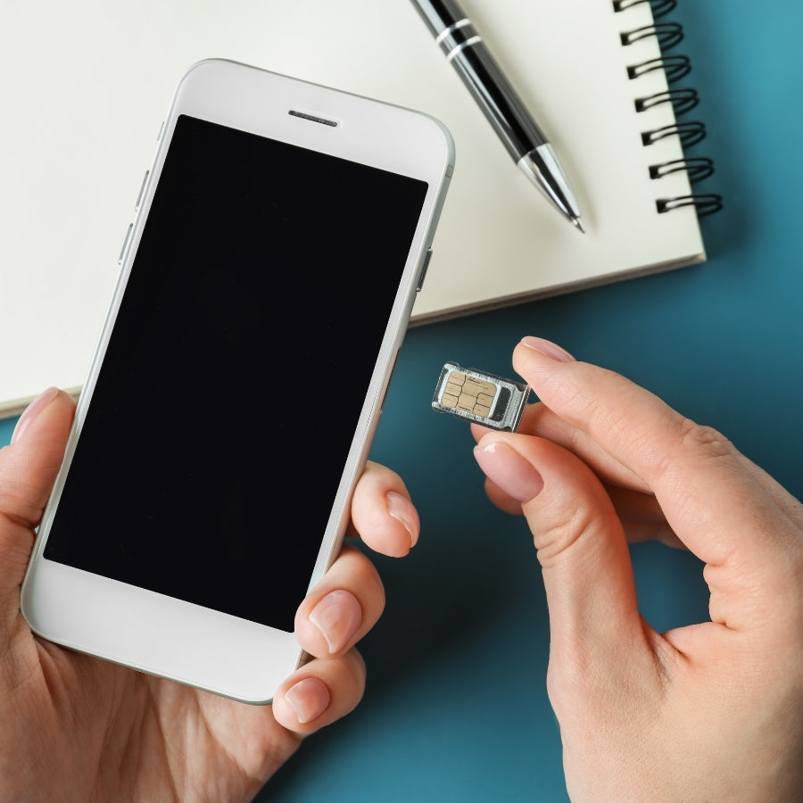 holding a phone and sim card