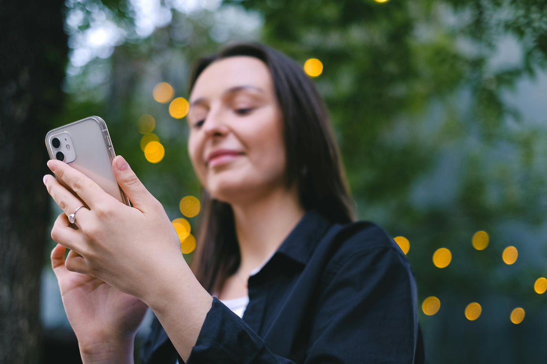 woman playing using iphone 11 in nature