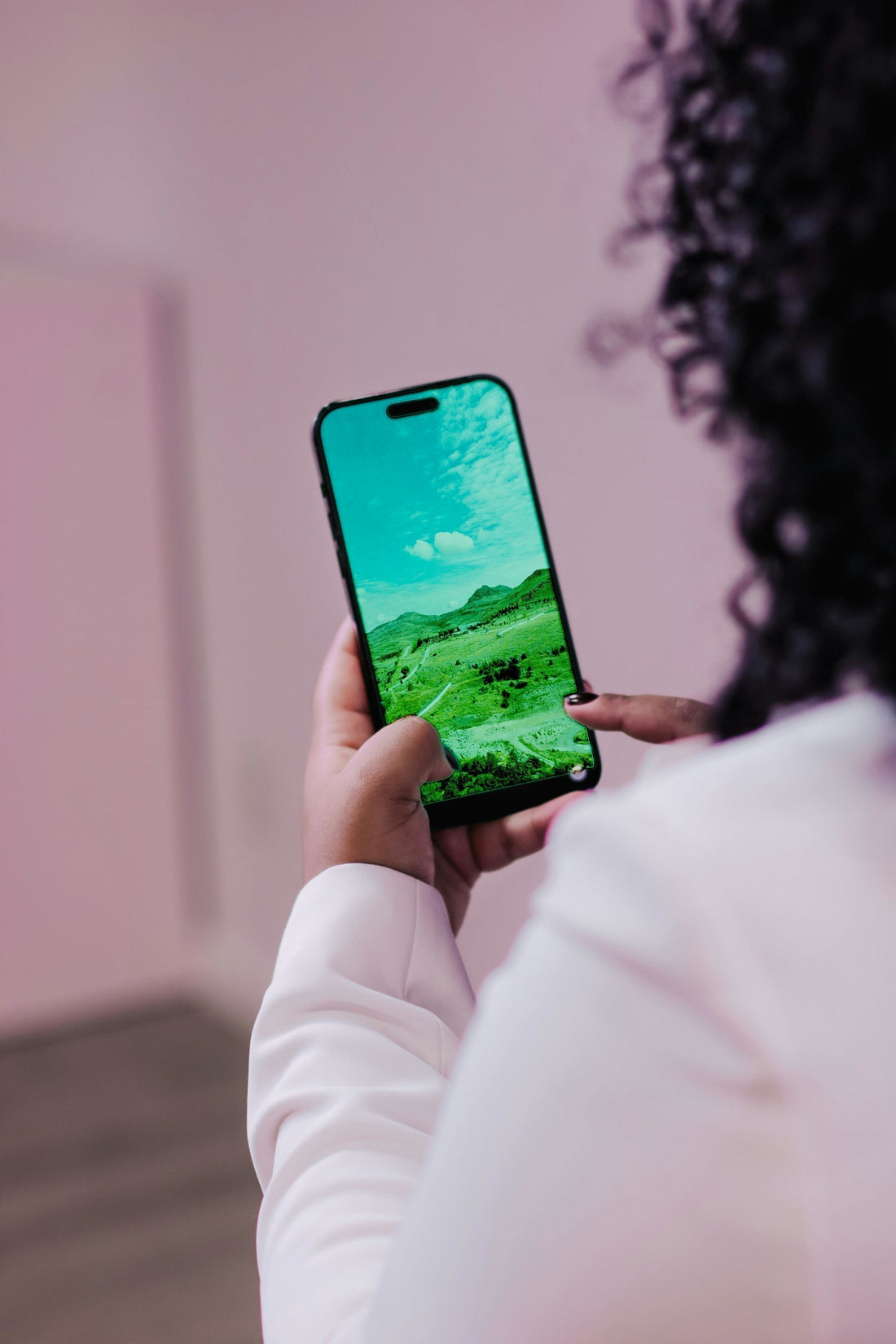 A woman with smartphone balancing it on her pinky
