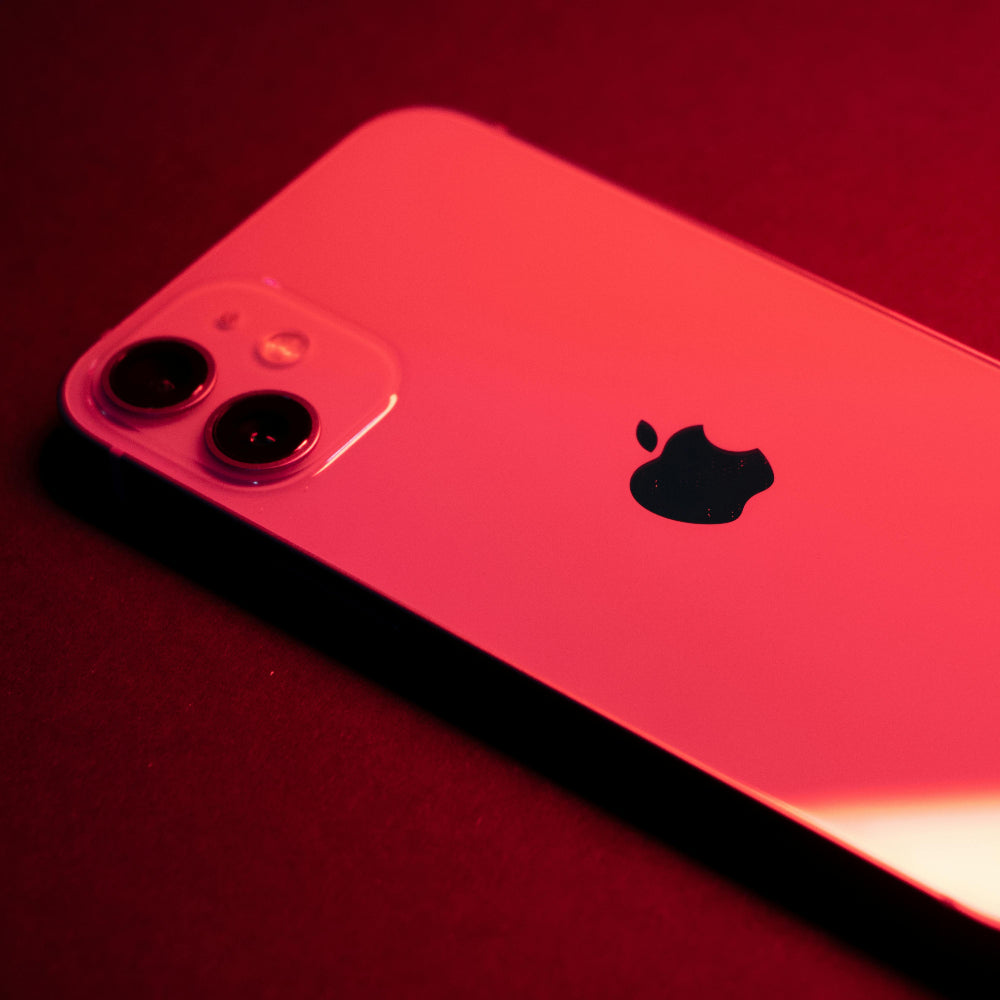 Red smartphone with Apple logo on a red background